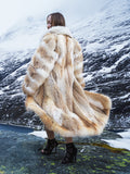 Coyote fur coat with white fox trim in snowy landscape