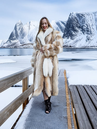 Coyote fur coat with white fox trim on snowy dock