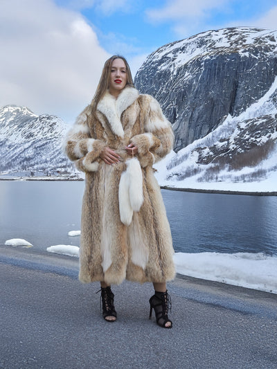 Coyote fur coat with white fox trim by snowy lake