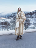 Coyote fur coat with white fox trim on snowy road