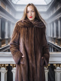 Woman wearing a brown fur coat in an elegant interior setting