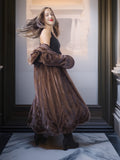 Woman wearing a long brown fur coat in an elegant interior setting