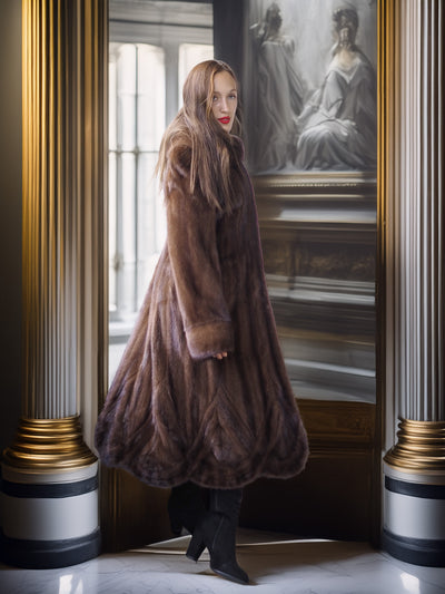 Woman in a fur coat standing in a room with classical architecture and a painting in the background.