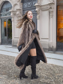 Twirl motion of Canadian Raccoon Fur Coat in silver tips, paired with black mini dress and boots for luxury winter style.