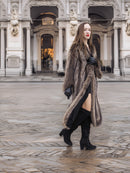 Model walking in Canadian Raccoon Fur Coat with silver tips, showcasing full-length fur and elegant winter fashion.