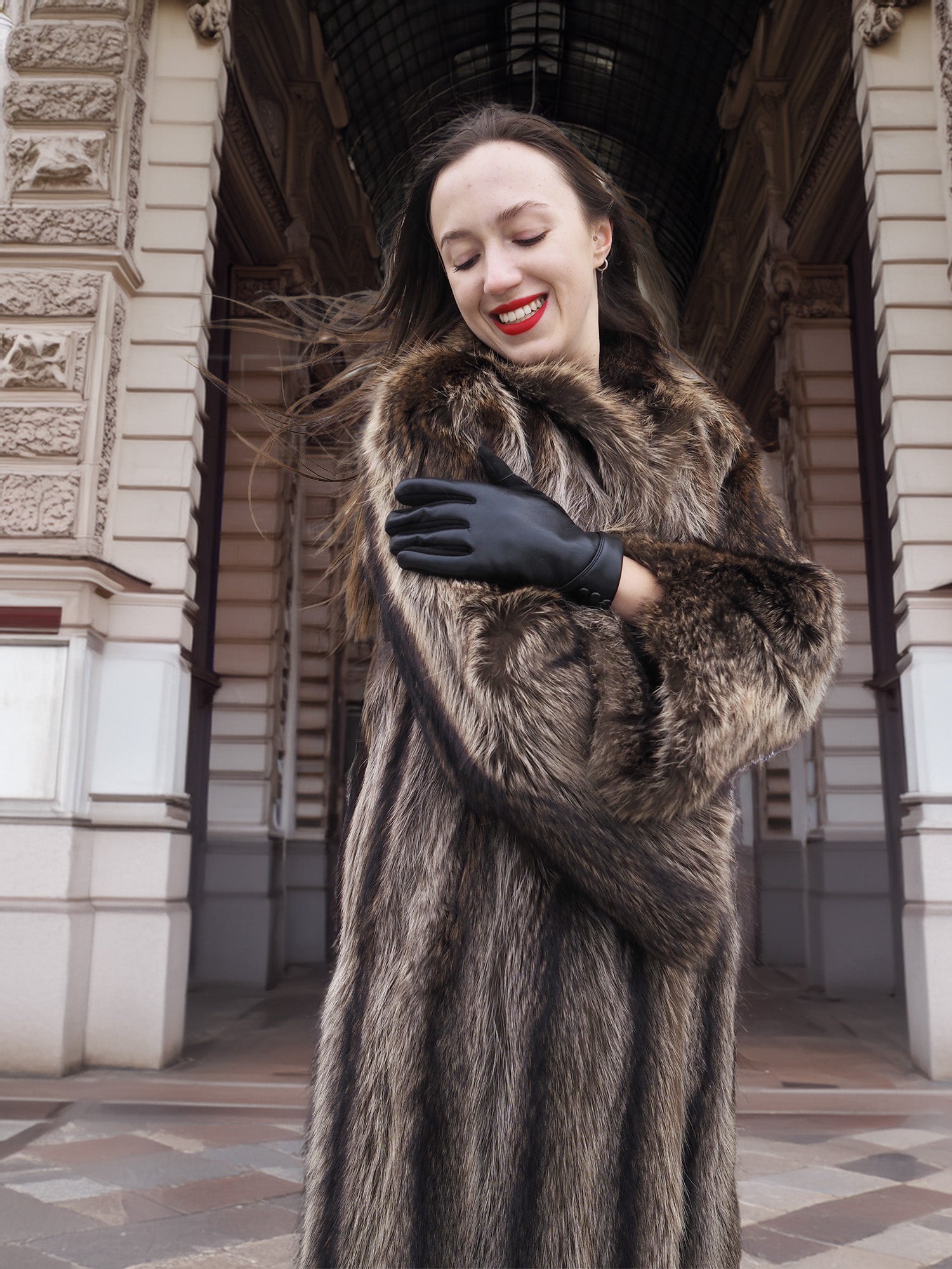 Close-up of Canadian Raccoon Fur Coat with silver tips, highlighting plush fur texture and scalloped sleeve design for winter fashion.