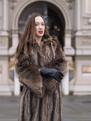 Model posing in Canadian Raccoon Fur Coat with silver tips, emphasizing plush fur texture and elegant winter outerwear.