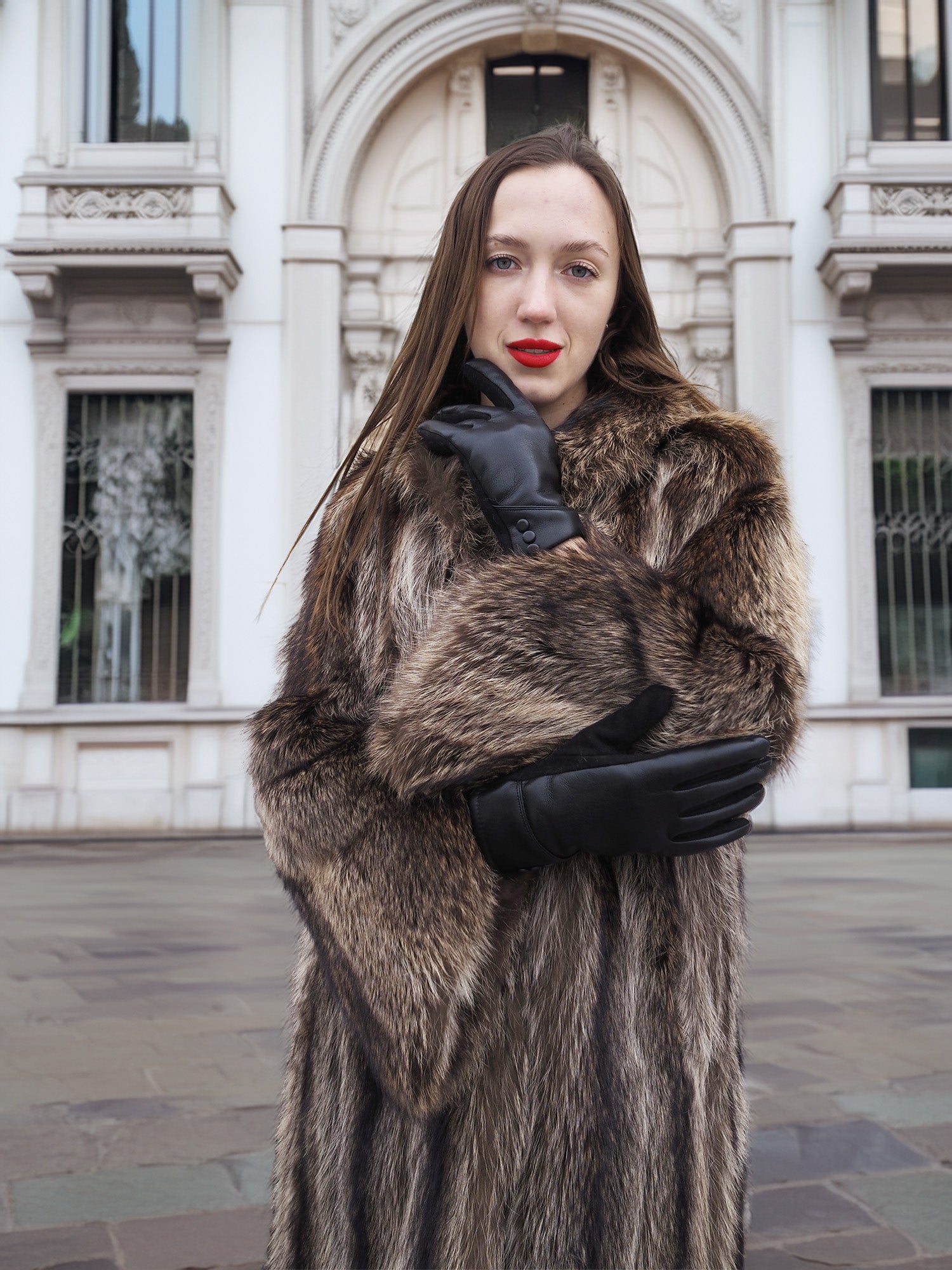 Model in Canadian Raccoon Fur Coat with silver tips, showcasing plush fur sleeves and luxury winter coat design.