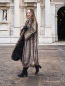 Side pose in Canadian Raccoon Fur Coat with silver tips, highlighting scalloped hem and plush fur for winter outerwear.