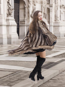 Canadian Raccoon Fur Coat in silver tips twirling motion, showcasing scalloped hem and luxurious fur texture.