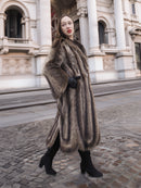 Side profile of Canadian Raccoon Fur Coat in silver tips, highlighting natural fur texture and elegant winter fashion silhouette.