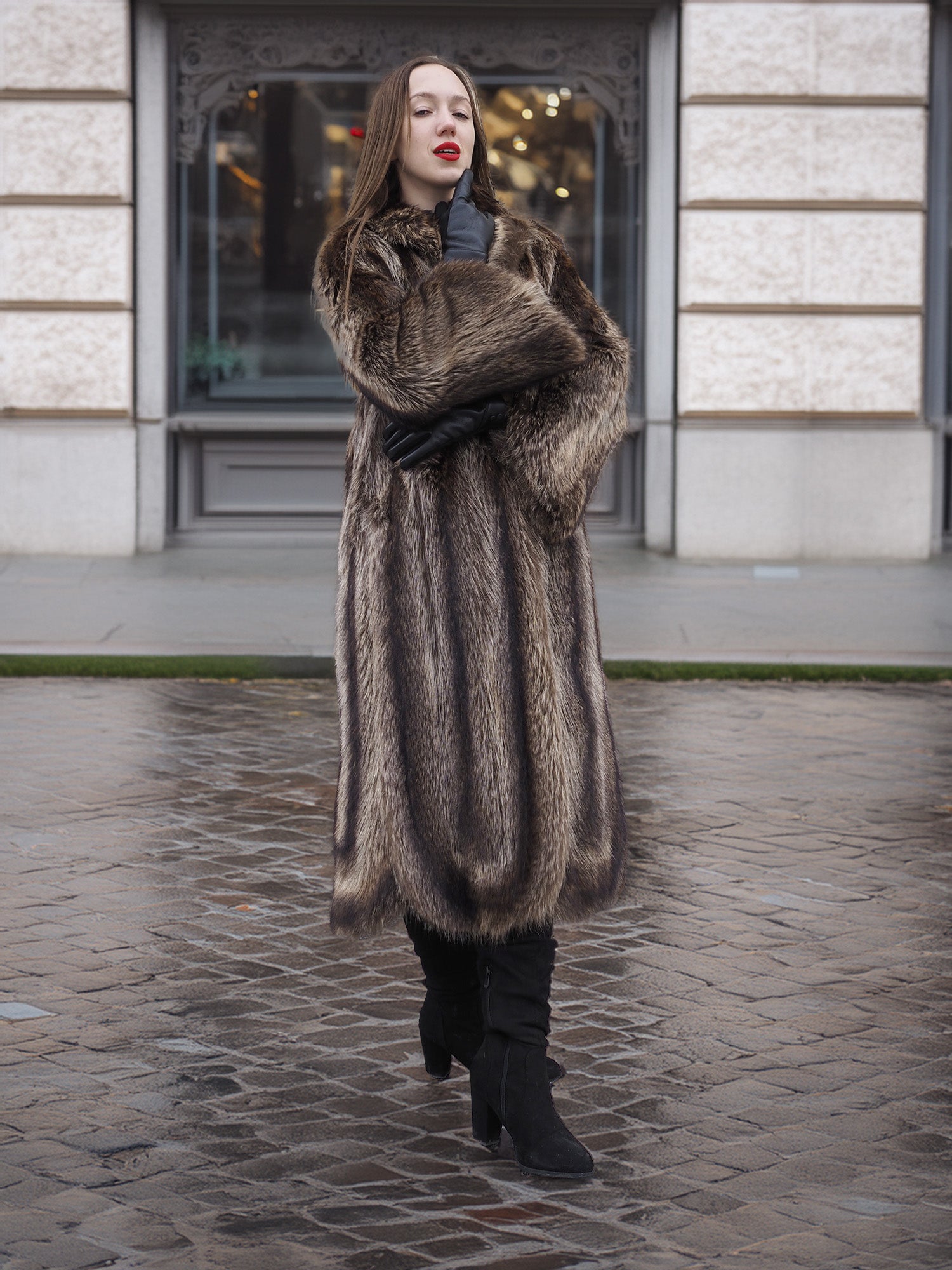 Canadian Raccoon Fur Coat in silver tips worn with black gloves and boots, perfect for stylish and warm winter fashion.