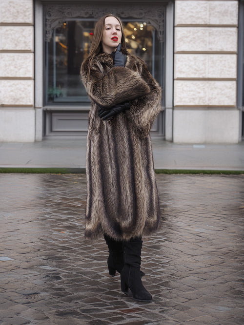Canadian Raccoon Fur Coat in silver tips worn with black gloves and boots, perfect for stylish and warm winter fashion.