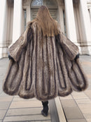 Back view of full-length Canadian Raccoon Fur Coat in silver tips, showcasing scalloped hem and luxurious natural fur texture.