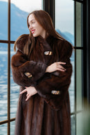 Close view of rich brown mink coat collar and sleeves with metal clasp accents