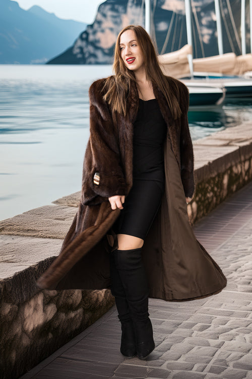Rich brown mink coat draping over arms, belted waist and oversized collar detail