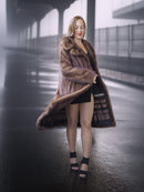 Woman wearing a fur coat on a foggy street