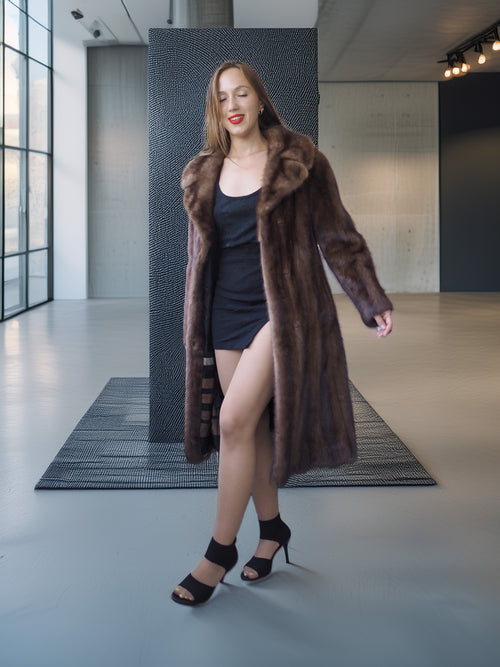 Woman wearing a fur coat in an indoor setting