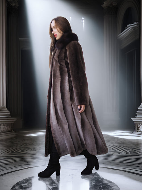 Woman wearing a long brown coat in an elegant interior setting