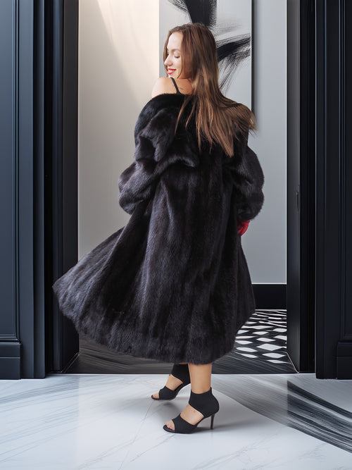 Woman wearing a black fur coat in a stylish interior setting