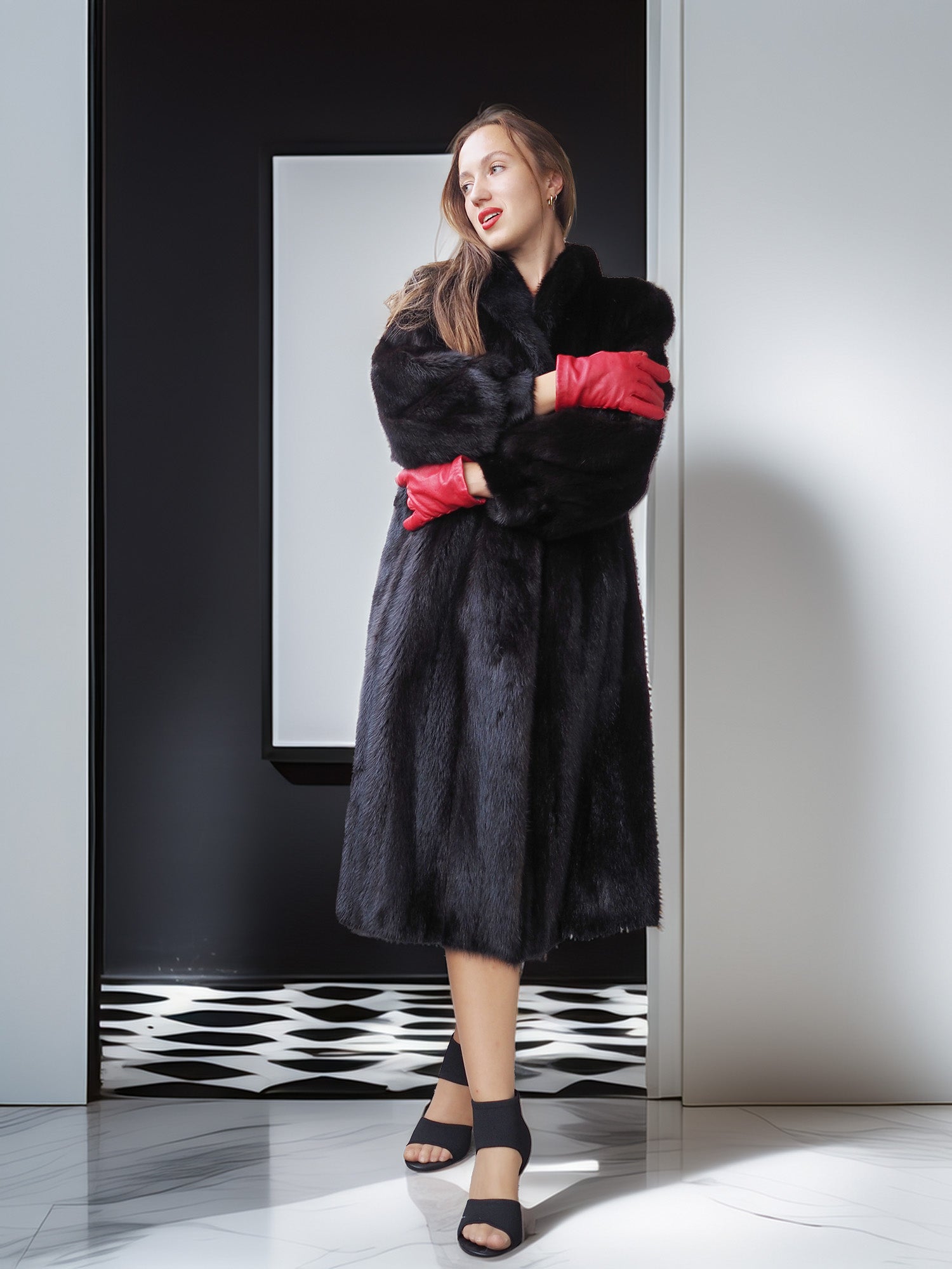 Woman wearing a black fur coat with red lining standing in front of a mirror.