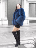 Elegant blue fox fur coat with a soft crew neck, worn with a black mini skirt and red gloves. A statement piece for winter fashion enthusiasts.