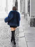 Back view of a luxurious blue fox fur coat with voluminous sleeves. A stylish and warm outerwear choice for winter fashion.