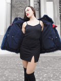 Stylish blue fox fur jacket with a rich texture, paired with a red handbag. A luxurious winter coat for fashion-forward individuals.