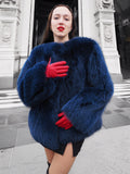 Luxury blue fox fur coat with a plush texture, styled with red gloves. A warm and elegant outerwear piece for winter fashion lovers.