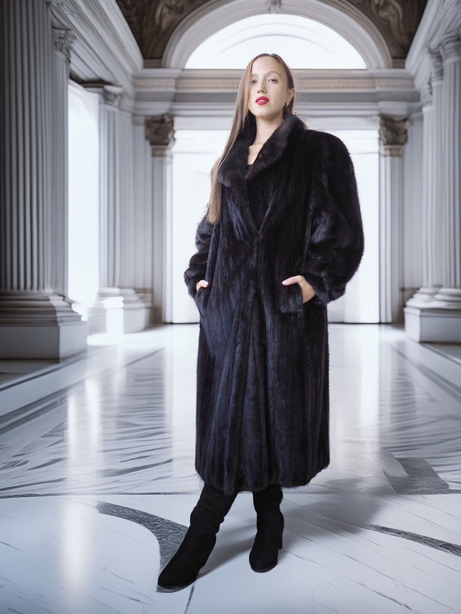 Woman wearing a long black fur coat in an elegant interior setting