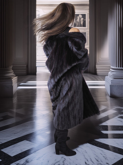 Person wearing a fur coat in an elegant interior setting