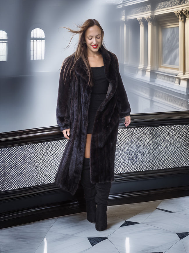 Woman wearing a long black fur coat in an elegant interior setting