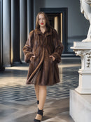 Woman wearing a brown fur coat in an elegant interior setting
