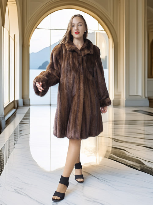 Woman wearing a brown fur coat in an elegant interior setting