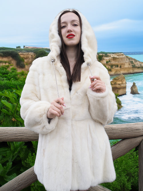 Beige Pearl Mink Fur Coat with hood, offering chic warmth and elegance. Features hook-eye closure, satin lining, and pockets for a luxurious feel.
