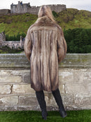 Back view of Fisher Sable Fur Coat by stone wall