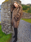 Fisher Sable Fur Coat leaning on stone wall