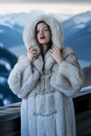 Hooded plush blue fox coat with thick collar, front ties, and long straight fit