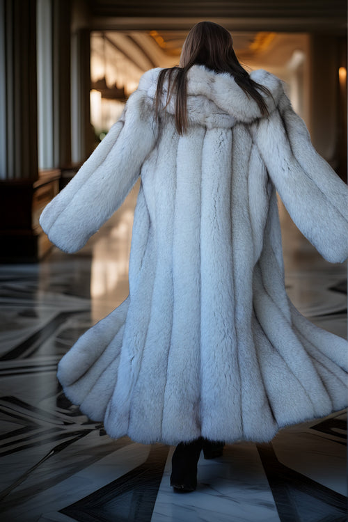 Person wearing a long white fur coat in an elegant interior setting