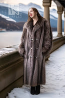Long raccoon fur double-breasted coat with notched lapels and silver button front
