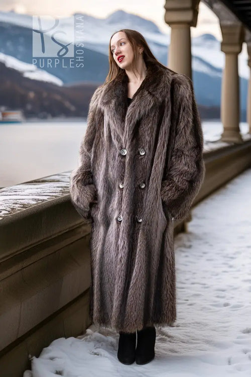 Long raccoon fur double-breasted coat with notched lapels and silver button front
