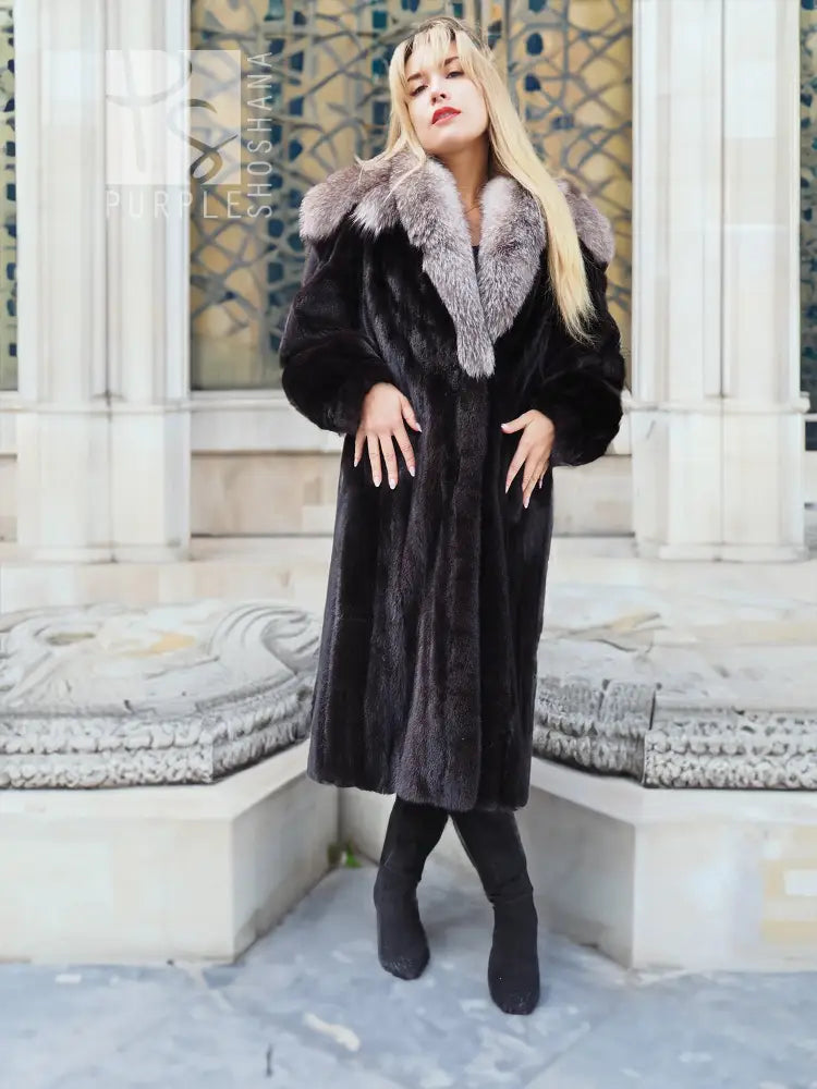 Black mink coat with light gray fox-fur cape collar, long silhouette and dark boots