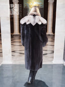 Black mink coat with flared sleeves and light fur collar detail, shown from back