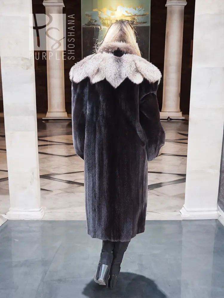 Black mink coat with flared sleeves and light fur collar detail, shown from back