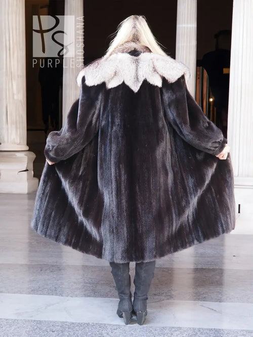 Black mink coat with full back drape and light fur collar, standing pose