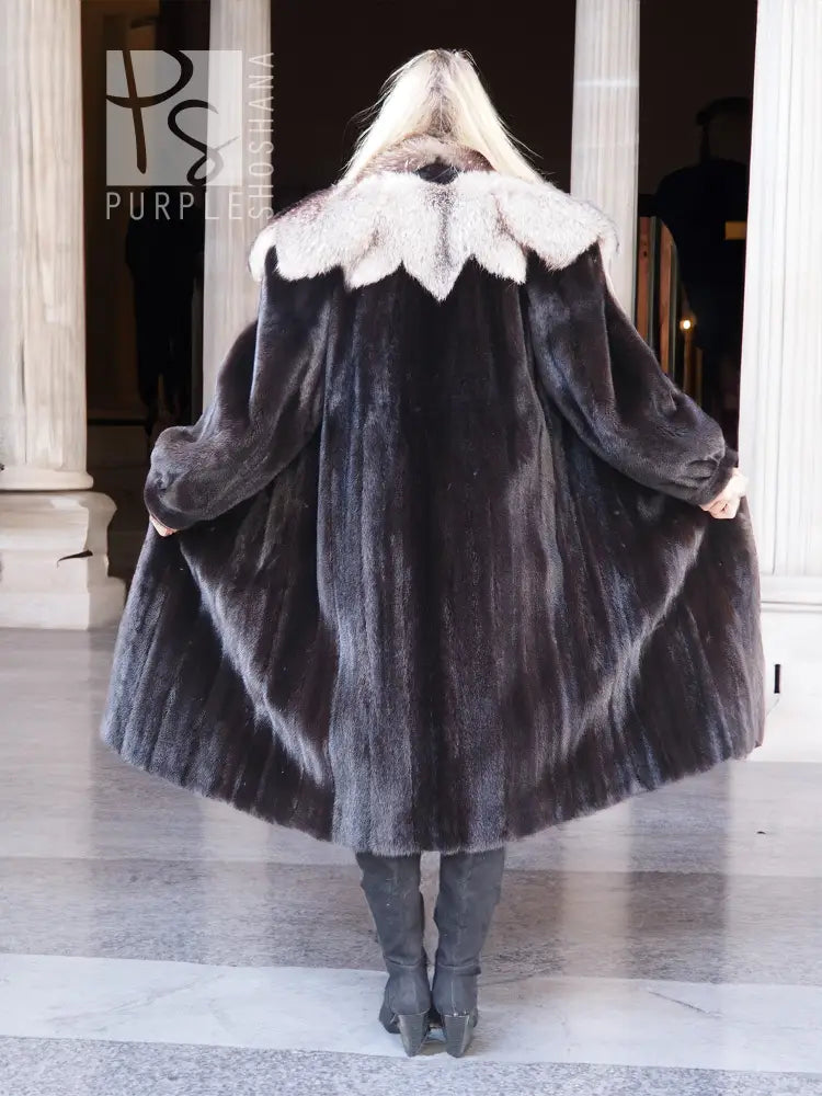 Black mink coat with full back drape and light fur collar, standing pose