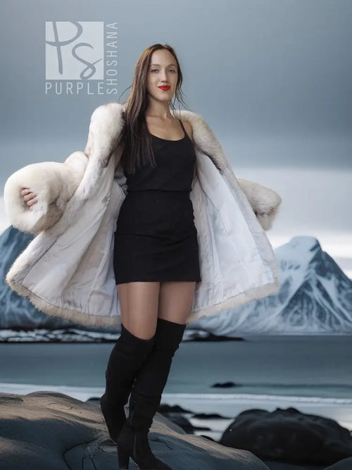 Light cream hooded fur jacket worn over a short black dress