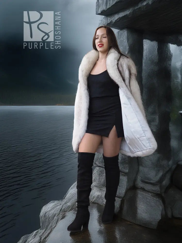 Light cream hooded fur jacket with open front over a dark mini dress