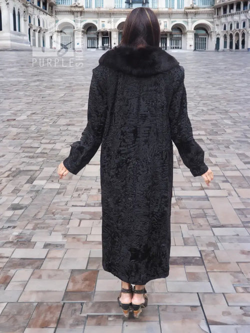Long lambswakara broadtail coat in dark black, fur-trimmed hood (back view)