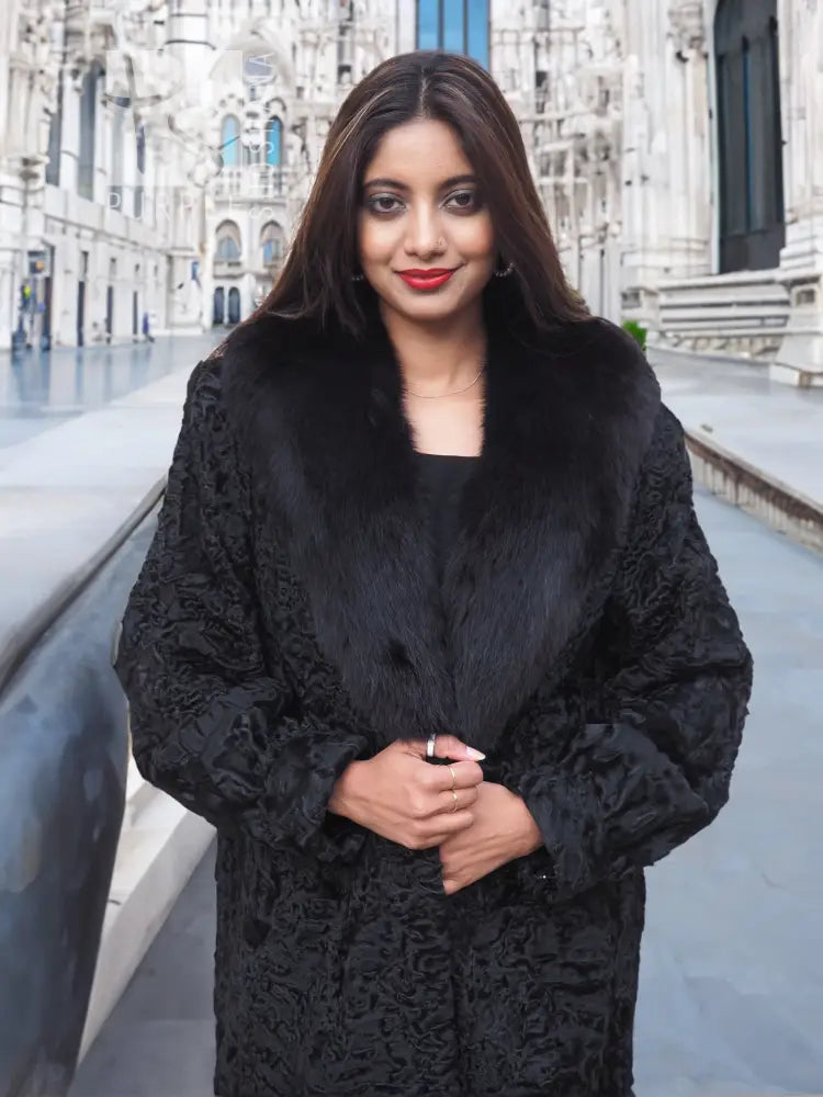 Black long fur coat with shawl collar and textured pattern, front close-up